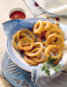 Onion rings on white plate with blue napkin