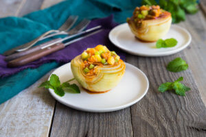 teriyaki stuffed onion on white plate on wooden background