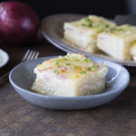Four Onion Scalloped potatoes in blue bowl