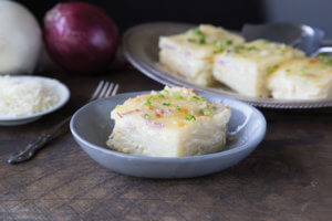 Four Onion Scalloped potatoes in blue bowl