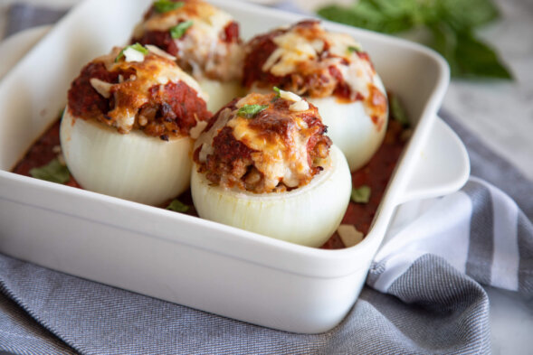 Stuffed Onions with Marinara in white baking dish