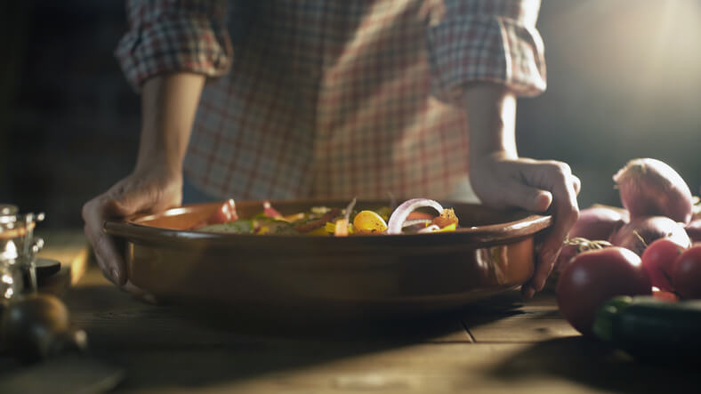 woman standing over a pot of comfort food