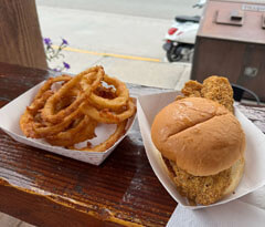 Maggies Onion Rings next to sandwhich