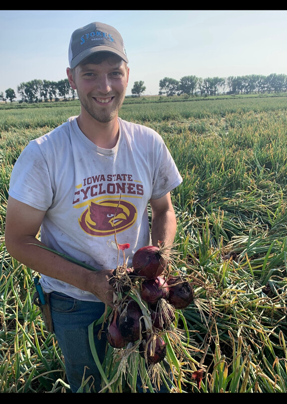 Adam Koch in an onion field in college.