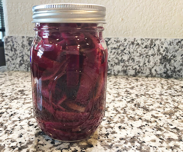 Mason jar of pickled red onions